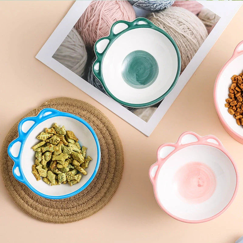 Ceramic pet bowl with 15-degree incline design in pink, green, and blue