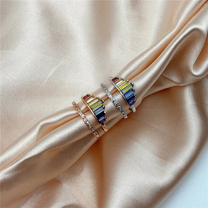 Stylish rainbow micro-diamond ring with a geometric design, available in silver and rose gold finishes
