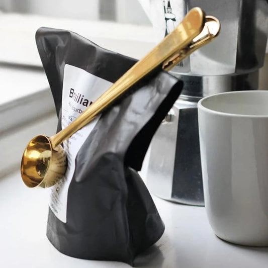 Versatile stainless steel coffee scoop with clip for sealing coffee bags and measuring grounds