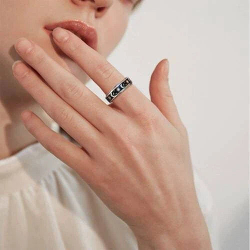Elegant stainless steel spinner ring with a captivating moon and star design that rotates effortlessly for a calming tactile experience