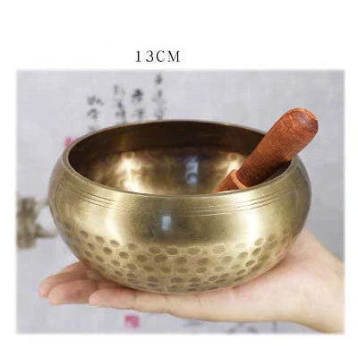 A handcrafted Tibetan singing bowl made of copper, used for meditation and relaxation.