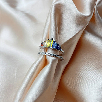 Stylish rainbow micro-diamond ring with a geometric design, available in silver and rose gold finishes