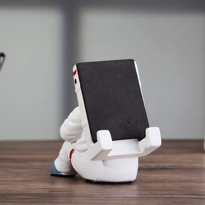 Charming astronaut-themed mobile phone stand made of high-quality resin, designed to securely hold your phone on your desk or workspace