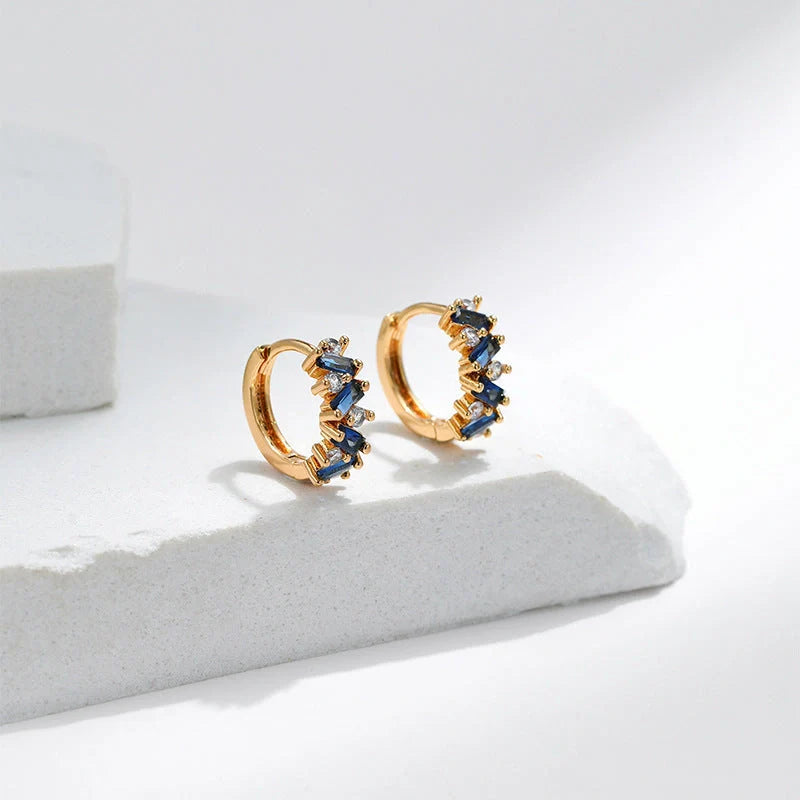 Elegant leaf-patterned ear clips with zircon and emerald gemstones, crafted in premium 18-carat gold-plated copper