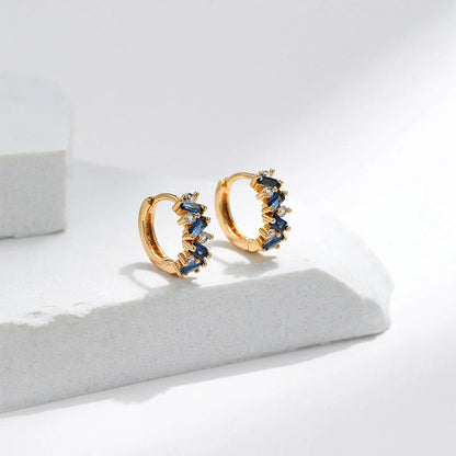 Elegant leaf-patterned ear clips with zircon and emerald gemstones, crafted in premium 18-carat gold-plated copper