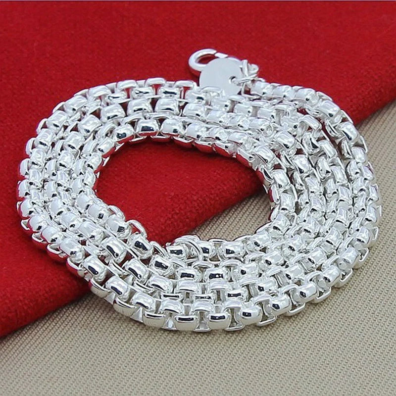 Silver-plated round pendant necklace with secure clasp, showcasing elegant British-inspired design