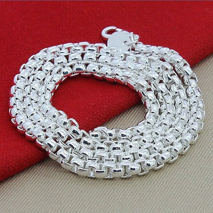 Silver-plated round pendant necklace with secure clasp, showcasing elegant British-inspired design