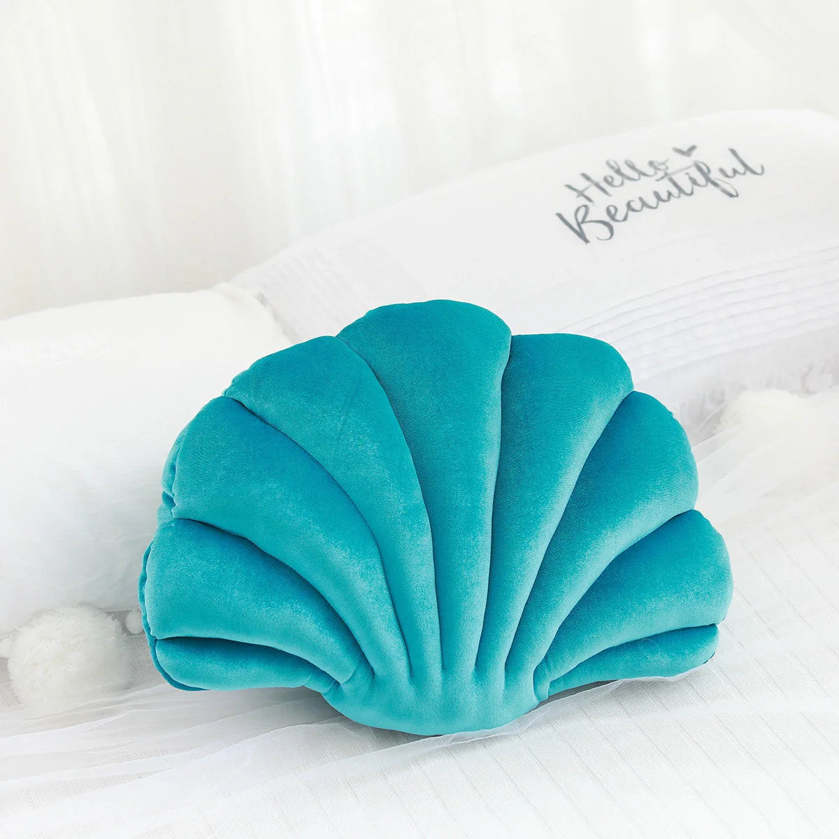 Cosy shell-shaped plush nap pillow in various colours and sizes for ultimate comfort