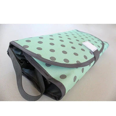 Portable diaper changing pad clutch with built-in toy ring, foldable design for easy transport