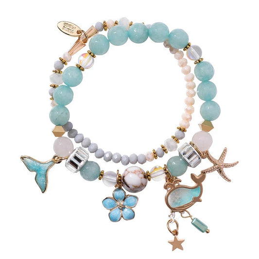 Elegant whale tail bracelet with floral charm in a variety of vibrant colours