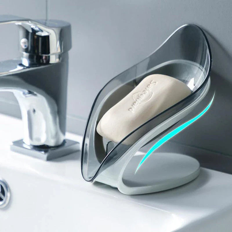 Elegant leaf-shaped soap dish with self-draining design and stable triangular shape, made of durable ABS material