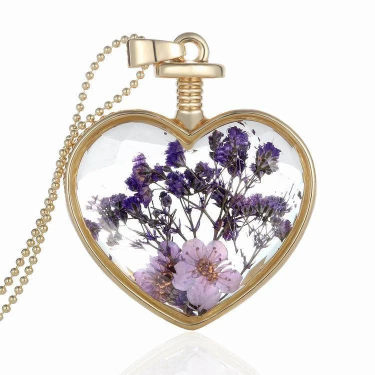 Elegant glass-encased dried flower pendant necklace with bead chain, showcasing a variety of preserved floral arrangements.
