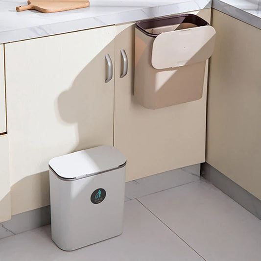 A durable plastic kitchen bin with a sliding lid, designed to be hung on the inside of a cabinet door for efficient waste disposal.