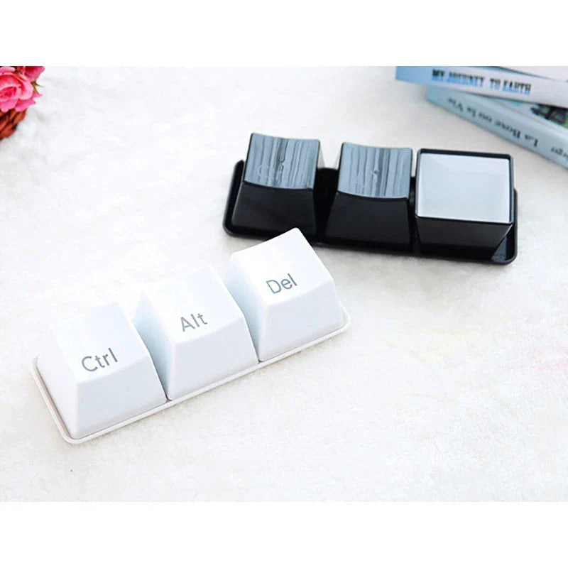 Three keyboard-inspired mugs in white and black colours, arranged on a wooden tray with a minimalist desk setting