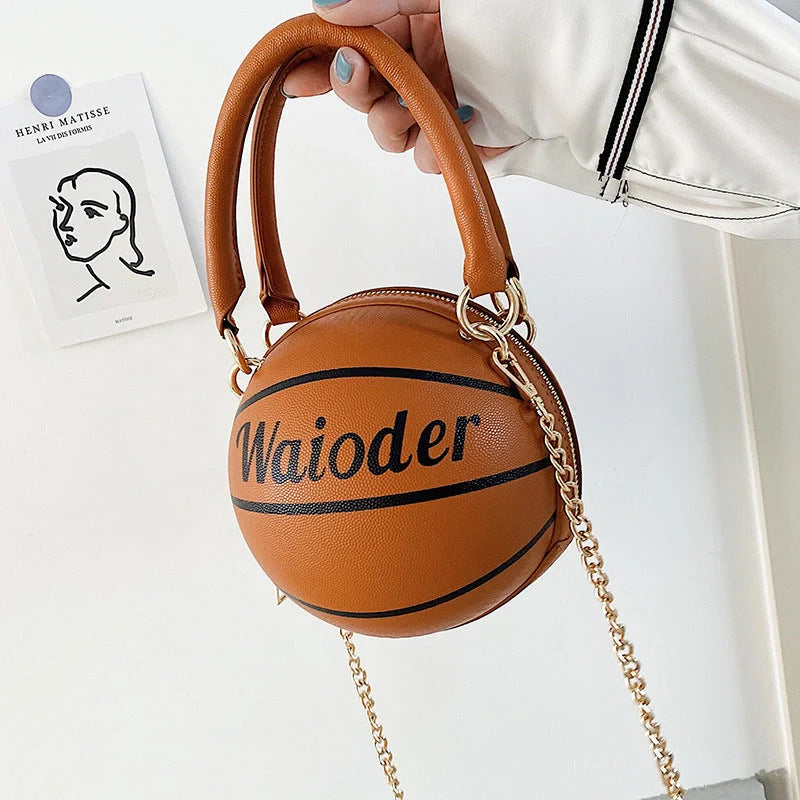 Basketball-shaped handbag in pink, white, black, or brown with adjustable chain shoulder strap