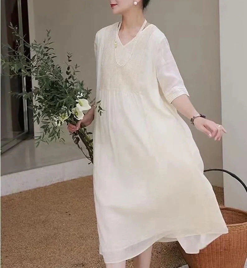 Women's white linen dress with relaxed fit, perfect for summer