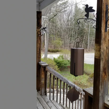 Handcrafted metal wind chimes in black and brown colors, available in small and large sizes, creating a serene outdoor ambiance