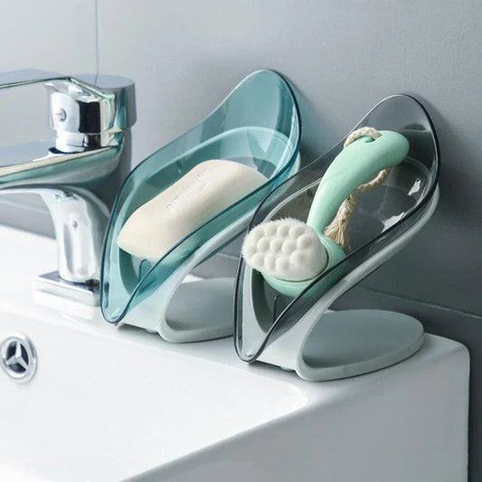 Elegant leaf-shaped soap dish with self-draining design and stable triangular shape, made of durable ABS material