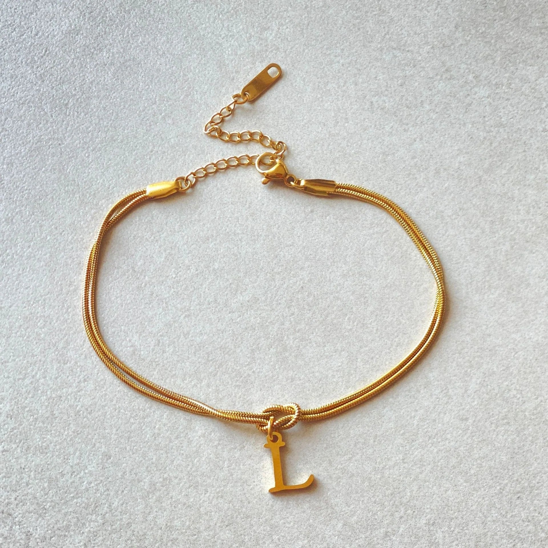 Personalised gold and silver love knot bracelets for couples, perfect as Valentine's Day gifts.