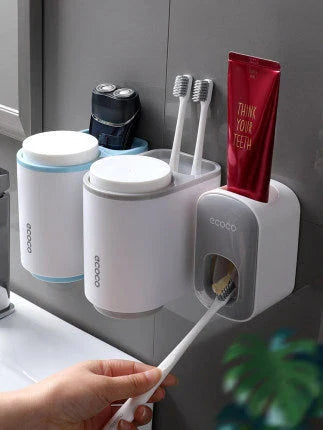 Wall-mounted automatic toothpaste dispenser with storage cups for toothbrush and bathroom accessories