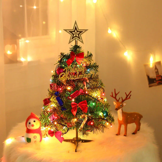 Mini Christmas tree with snowflake LED lights and decorative bows, bells, and pine cones