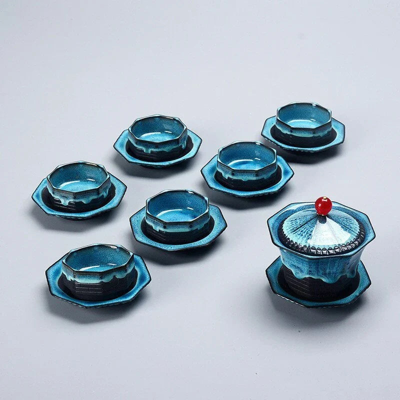 A beautiful porcelain tea set with a pagoda design, including a teapot, cups, trays, and a carrying bag for easy portability.