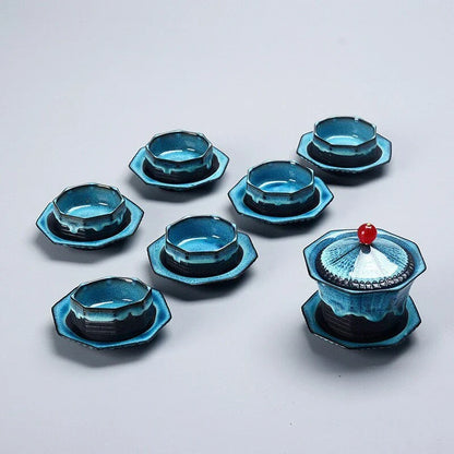 A beautiful porcelain tea set with a pagoda design, including a teapot, cups, trays, and a carrying bag for easy portability.