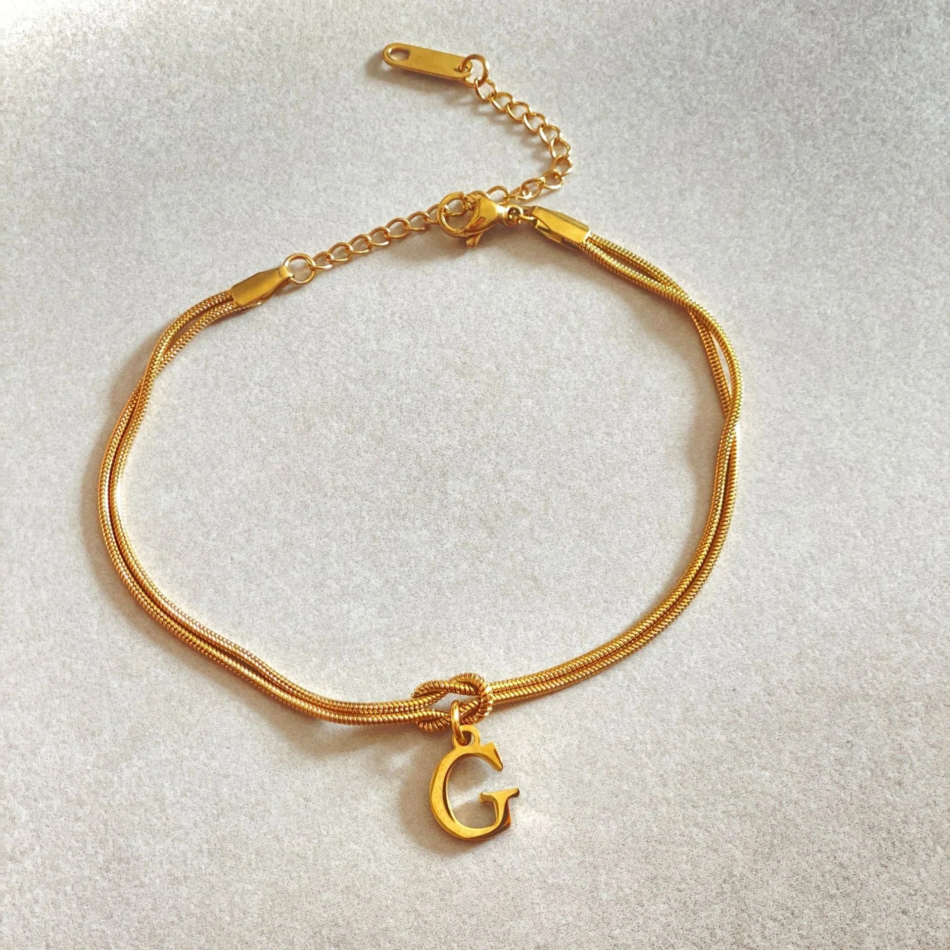 Personalised gold and silver love knot bracelets for couples, perfect as Valentine's Day gifts.
