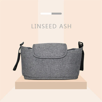 Stylish baby pram organiser bag made of premium cotton and linen materials, featuring various compartments and colour options to keep your child's essentials organised.