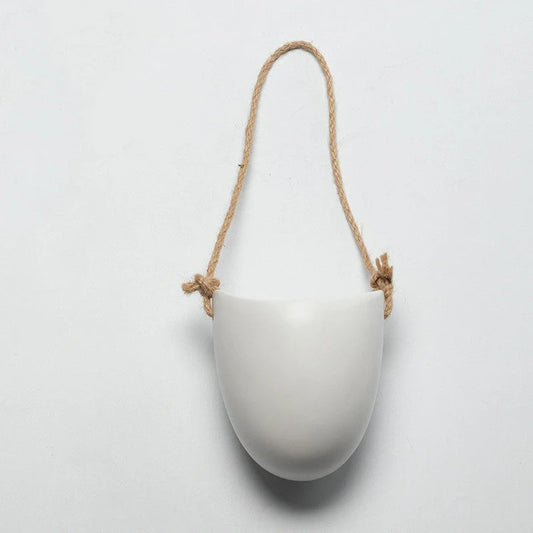 Wall-mounted ceramic flower pot in matte white with hemp rope for balcony gardening