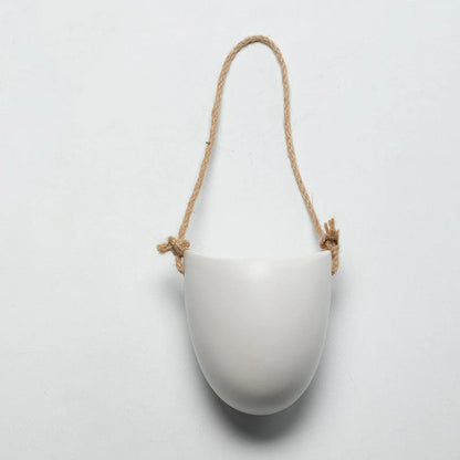 Wall-mounted ceramic flower pot in matte white with hemp rope for balcony gardening