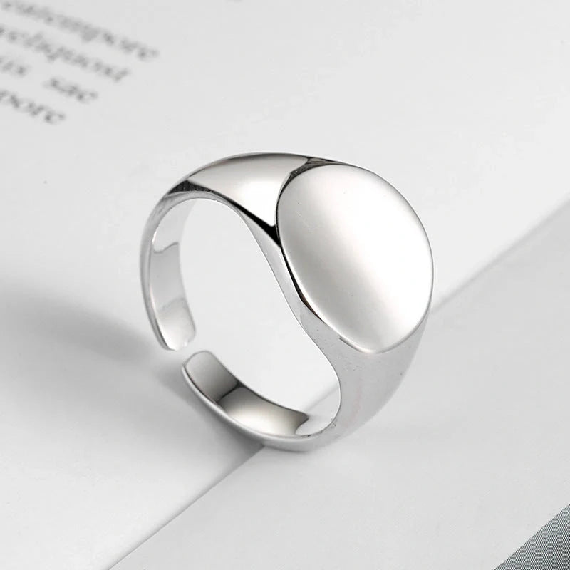 Adjustable oval smooth ring with polished electroplated finish in platinum and gold