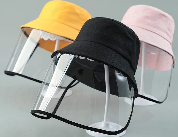 Child wearing anti-spitting protective hat with transparent bezel