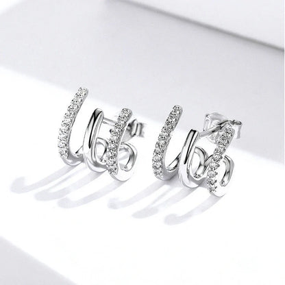 Elegant three-layer sterling silver heart earrings with sparkling gems, perfect for any occasion.