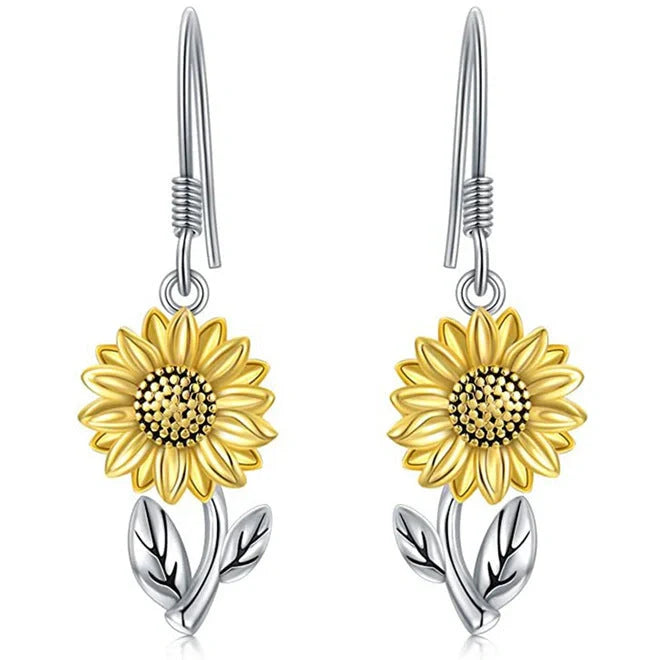 Elegant silver earrings featuring delicate bee and sunflower motifs, a stunning fashion accessory with natural charm.