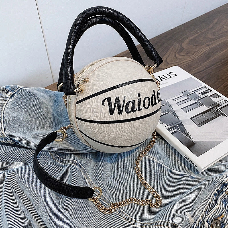 Basketball-shaped handbag in pink, white, black, or brown with adjustable chain shoulder strap
