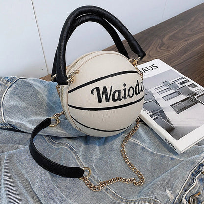 Basketball-shaped handbag in pink, white, black, or brown with adjustable chain shoulder strap