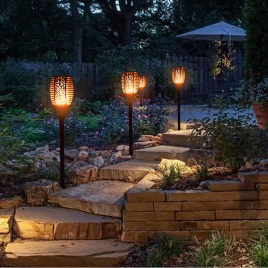 Elegant solar-powered garden lights illuminating a pathway in a lush British garden