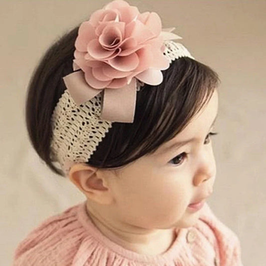 A beautiful floral headband for babies, featuring delicate flowers and a comfortable, adjustable design.