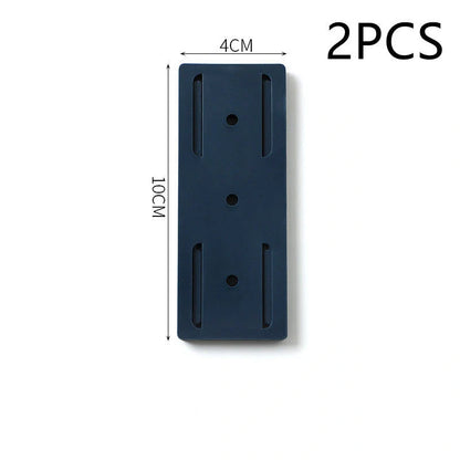 Self-adhesive wall hook in green, blue, white, and pink for cable organisation