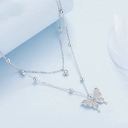 A stunning silver double-layer necklace with a captivating butterfly design and delicate fringed detailing