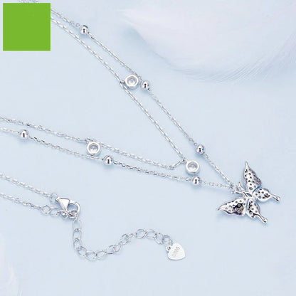 A stunning silver double-layer necklace with a captivating butterfly design and delicate fringed detailing