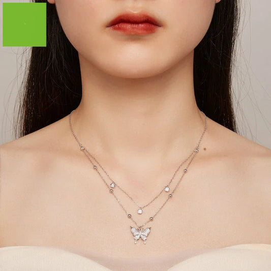 A stunning silver double-layer necklace with a captivating butterfly design and delicate fringed detailing