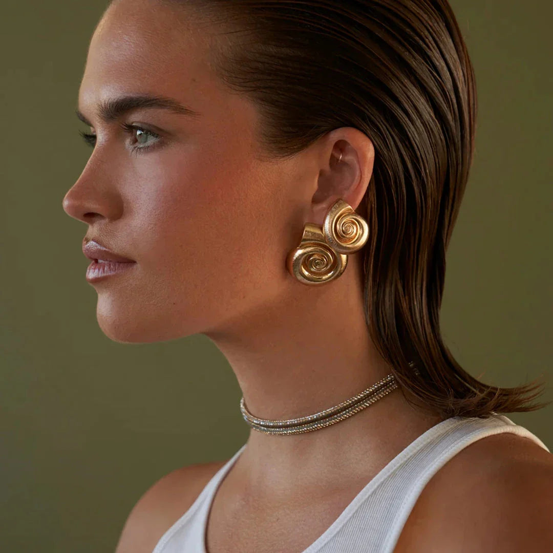 Pair of gold-plated stainless steel spiral conch earrings with a unique textured design