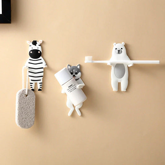 Assorted animal-shaped wall hooks in various colours, including bear, zebra, and cow designs, displayed on a white background