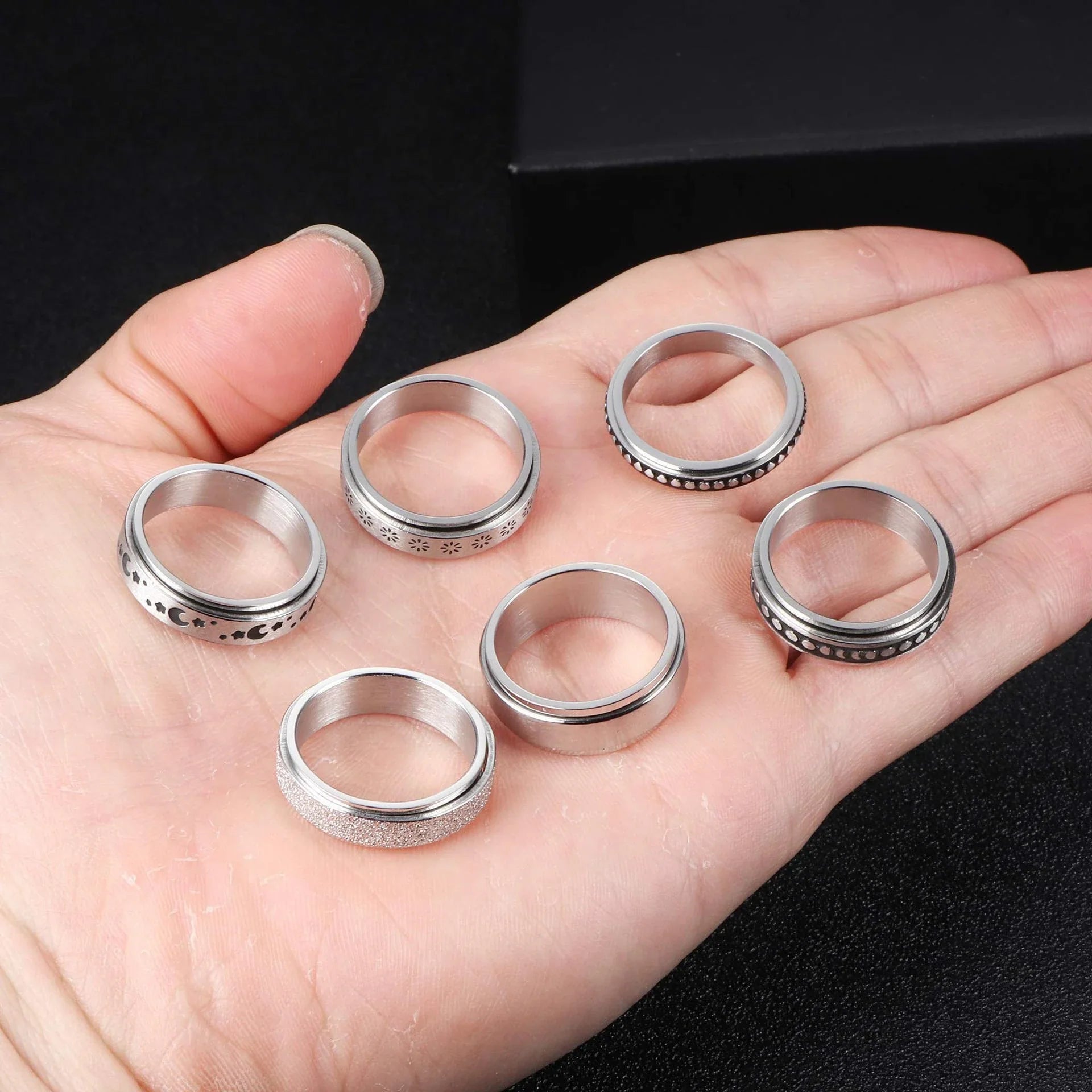 Elegant stainless steel spinner ring with a captivating moon and star design that rotates effortlessly for a calming tactile experience