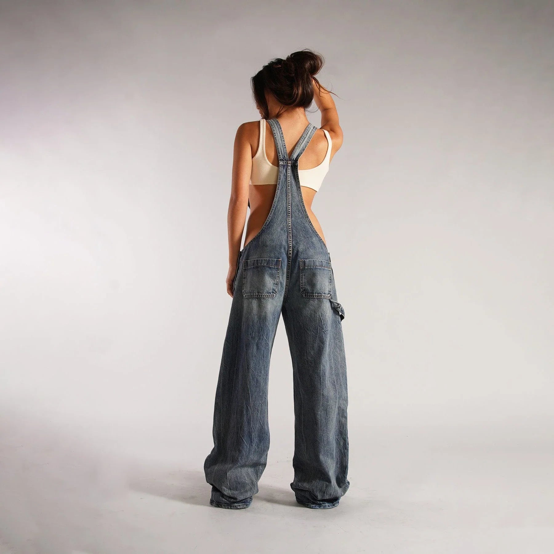 Stylish denim overalls with adjustable suspender straps, front and back pockets, and a comfortable micro-elastic fit, available in a variety of chic colors.