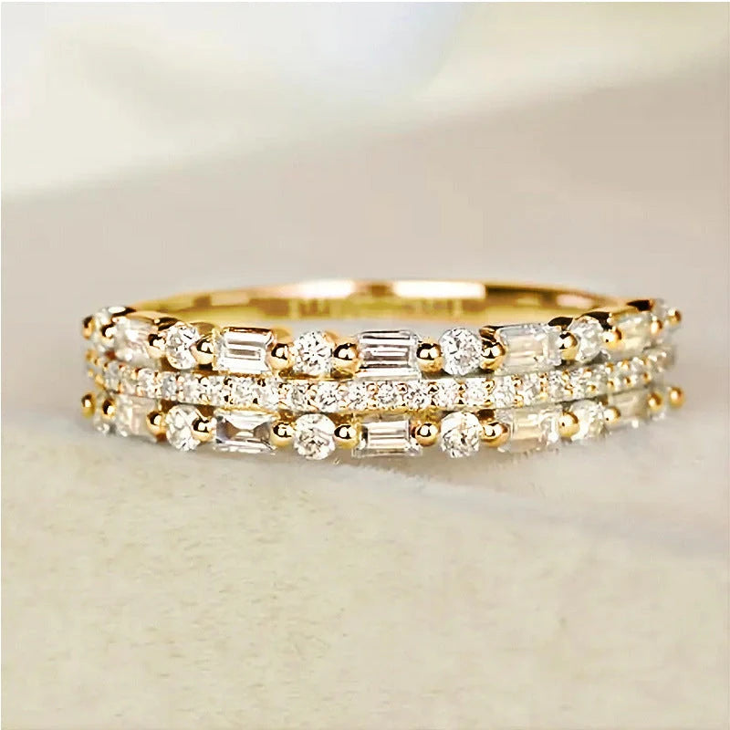 Elegant multilayer ring with a subtle geometric design, available in platinum, gold, and rose gold colours