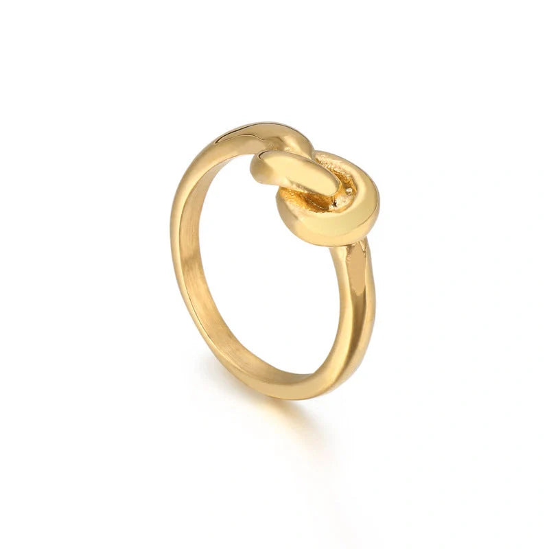 Sleek titanium steel geometric love knot ring in golden and rose gold colours, showcasing a modern and sophisticated design