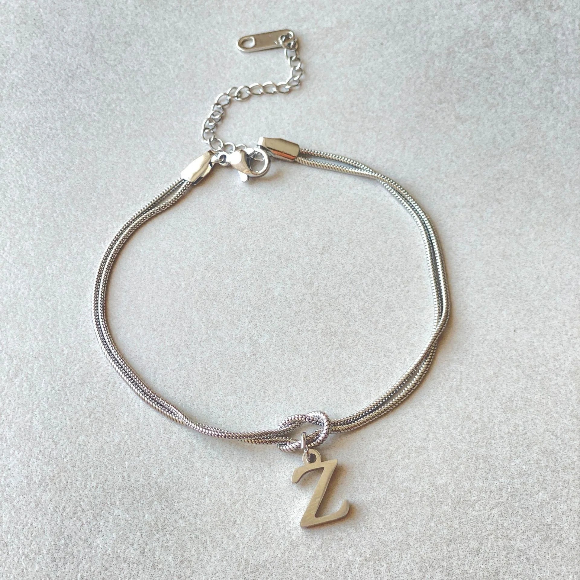 Personalised gold and silver love knot bracelets for couples, perfect as Valentine's Day gifts.